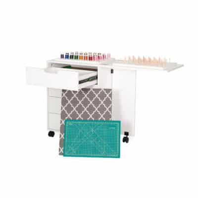 The Shirley Storage Cabinet is designed to perfectly complement your primary sewing workstation, featuring a built-in ironing station, cutting mat, and 4 drawers of dedicate storage for sewing notions and accessories!
