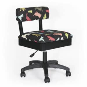 The Good Dog Hydraulic Sewing Chair features Dog’s Woof print with colorfully patterned pooches parading across a speckled black field. The heavy-duty upholstery fabric covers a perfectly designed ergonomic chair that helps you sew long hours.